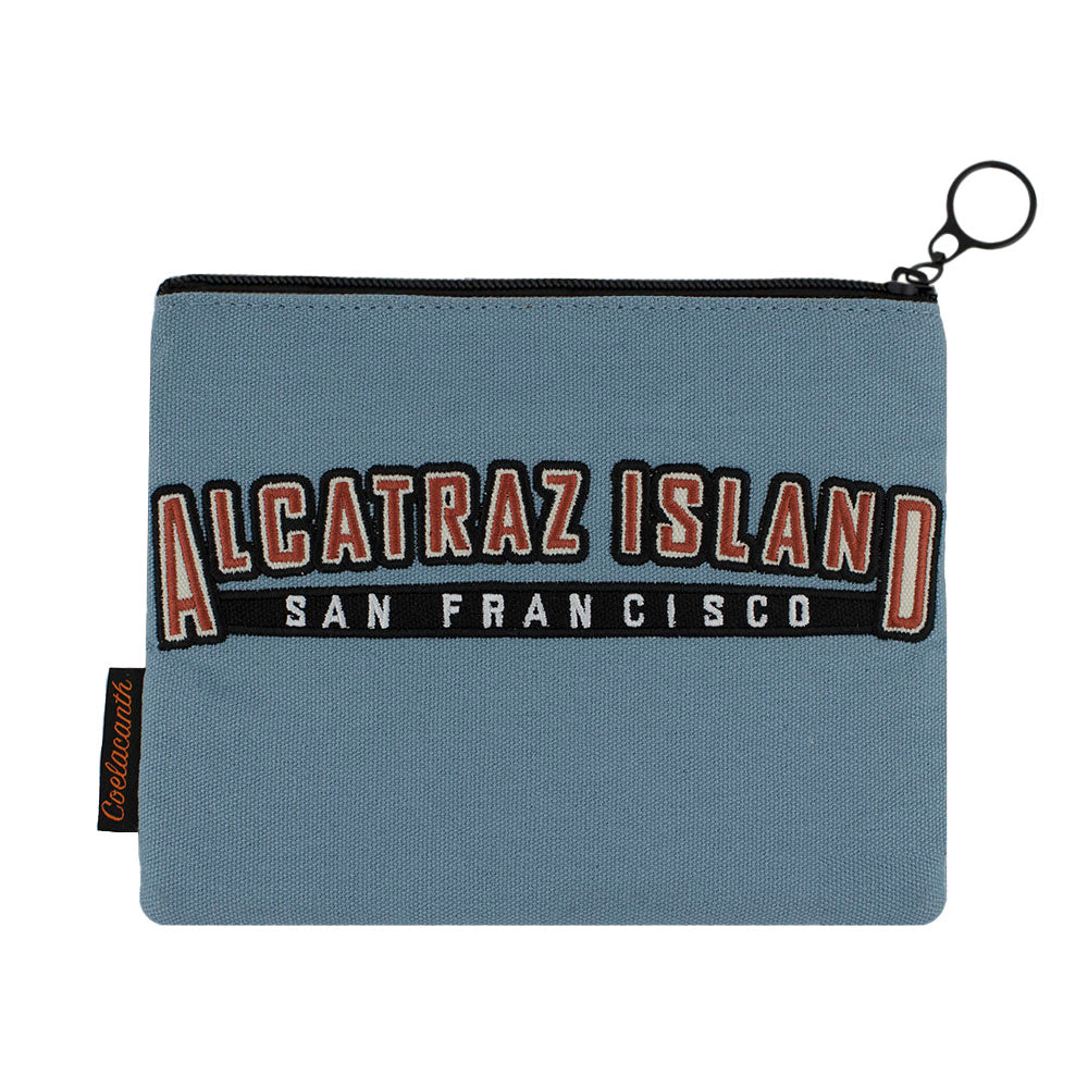 Blue zipper pouch with 'Alcatraz Island San Francisco' embroidered text in red, white, and black