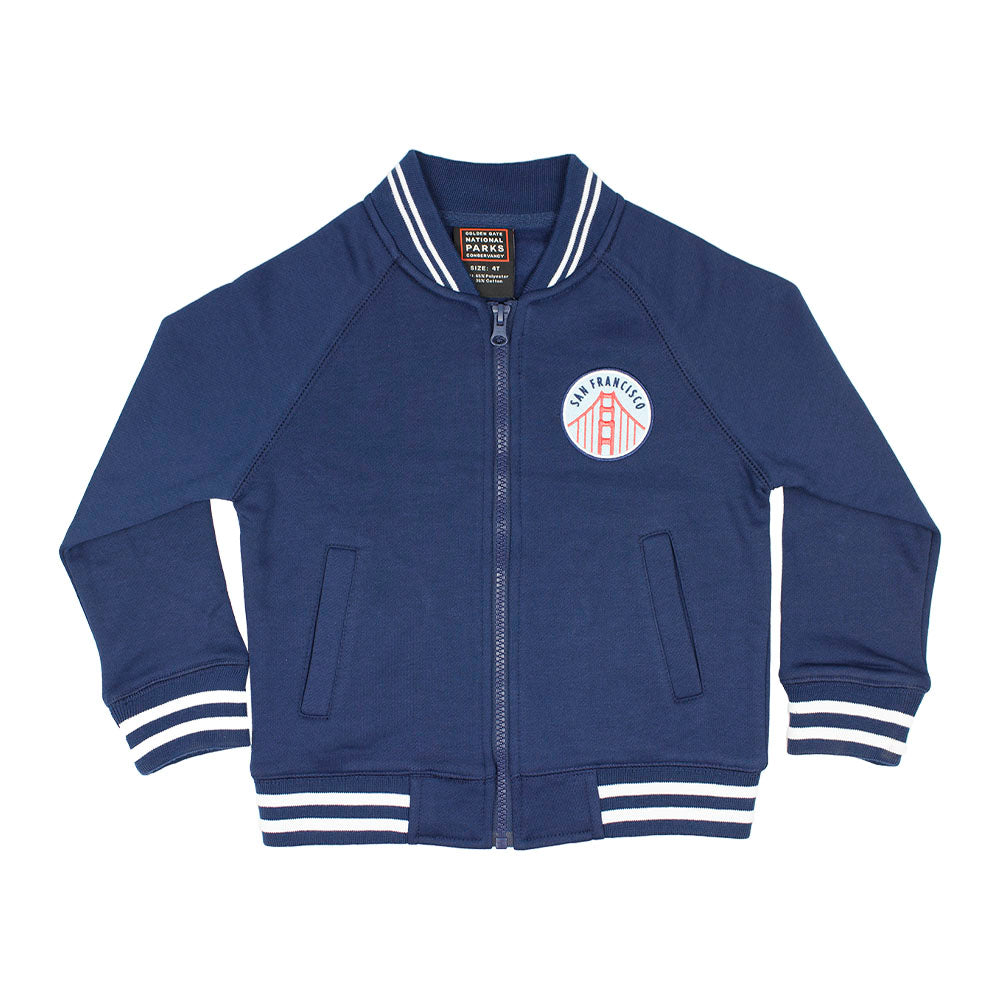 Blue kids varsity jacket with San Francisco Golden Gate Bridge logo on the chest against a white background