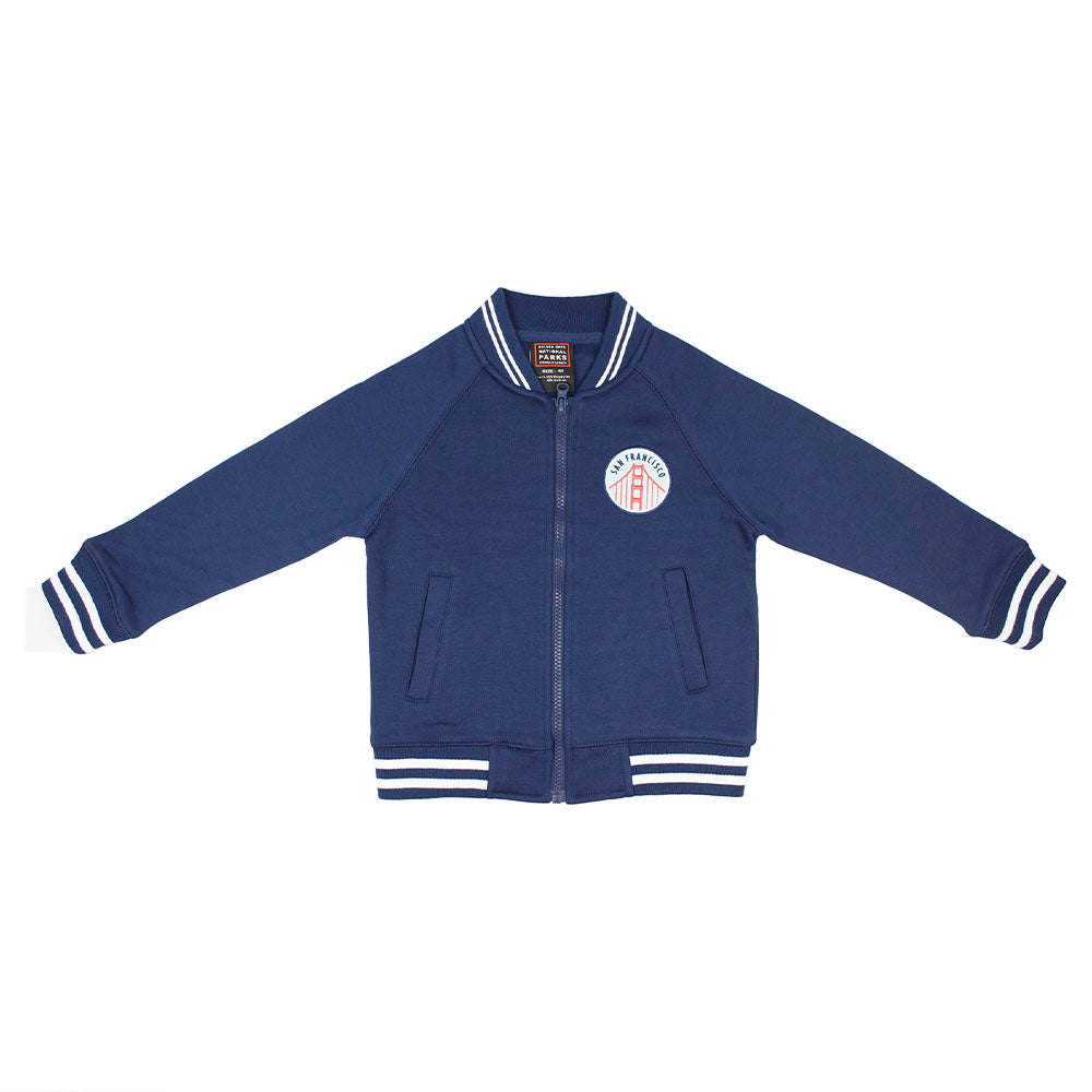 Blue kids varsity jacket with San Francisco Golden Gate Bridge logo on the chest against a white background