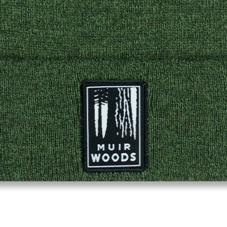Muir Woods logo on a green knit cap background