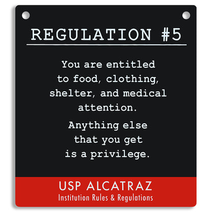 Sign with text from USP Alcatraz about rules and regulations, on a black and red background. "You are entitled to food, clothing, shelter, and medical attention. Anything else that you get is a privilege."