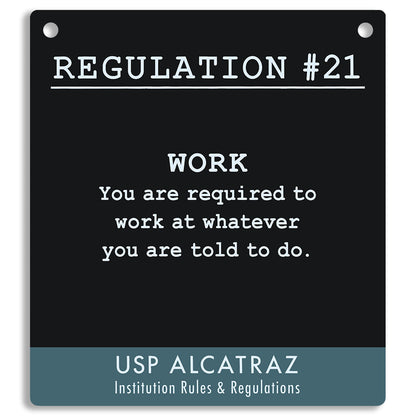Black sign with white text and blue border, featuring a regulation from USP Alcatraz. "You are required to work at whatever you are told to do."