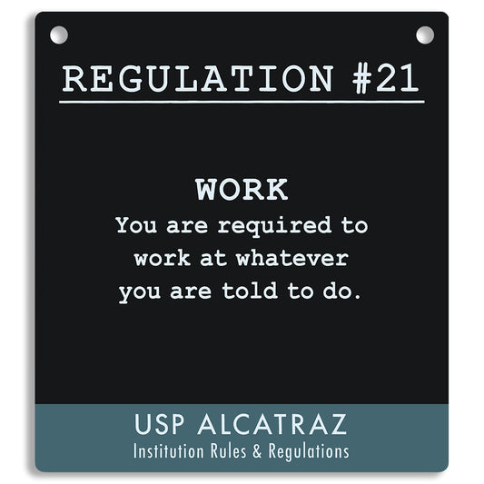 Black sign with white text and blue border, featuring a regulation from USP Alcatraz. "You are required to work at whatever you are told to do."