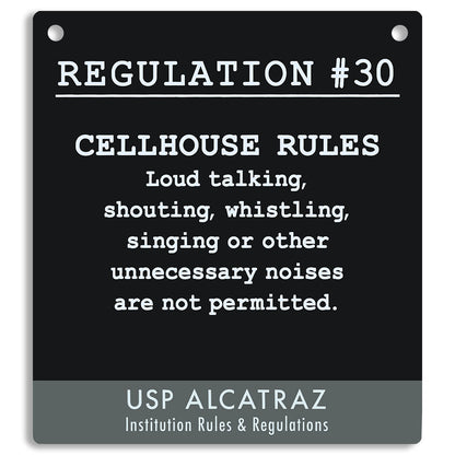 Black sign with white text listing cellhouse rules at USP Alcatraz, from Rules and Regulations. "Loud talking, shouting, whistling, singing or other unnecessary noises are not permitted."