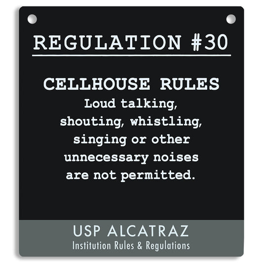 Black sign with white text listing cellhouse rules at USP Alcatraz, from Rules and Regulations. "Loud talking, shouting, whistling, singing or other unnecessary noises are not permitted."