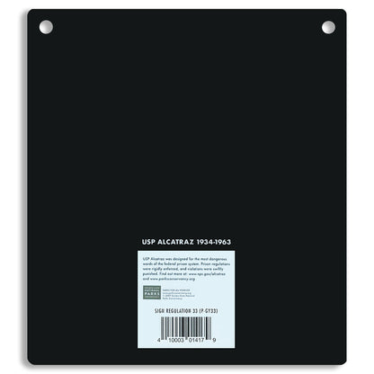 Black metal sign with 'USP Alcatraz 1934-1963' text on a white background