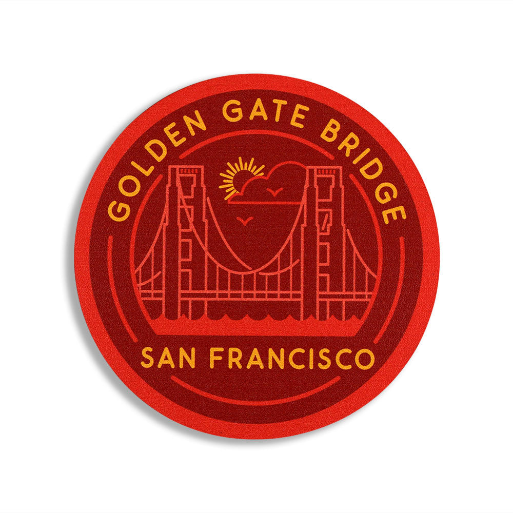 Circular coaster with red and orange Golden Gate Bridge San Francisco design and text