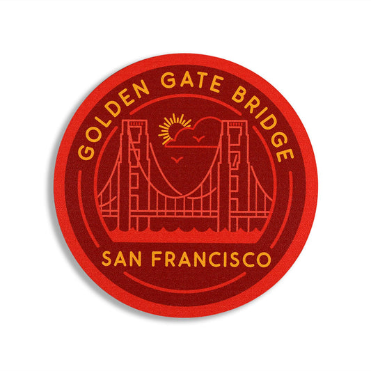 Circular coaster with red and orange Golden Gate Bridge San Francisco design and text