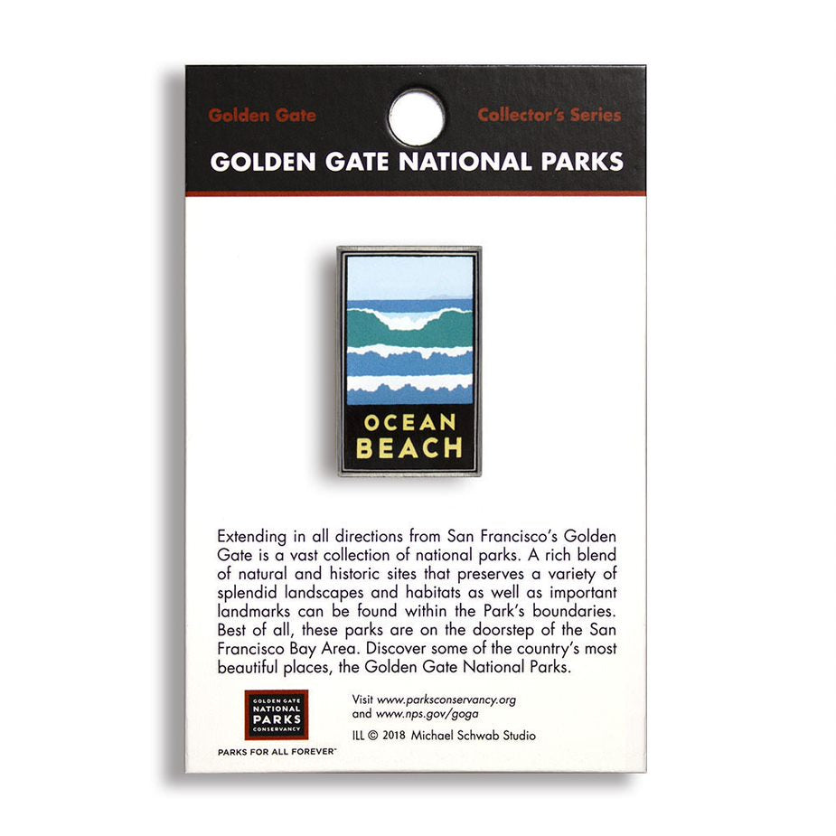 A pin with a blue, white, and green ocean and beach design, labeled 'Ocean Beach' from Golden Gate National Parks, with a sturdy metal backing.