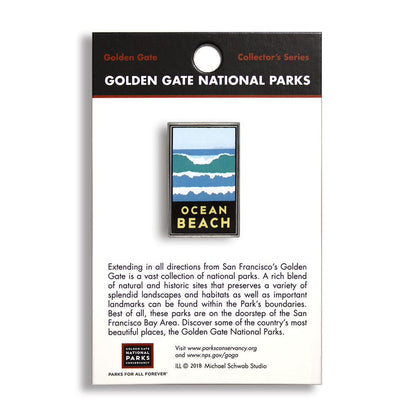 A pin with a blue, white, and green ocean and beach design, labeled 'Ocean Beach' from Golden Gate National Parks, with a sturdy metal backing.